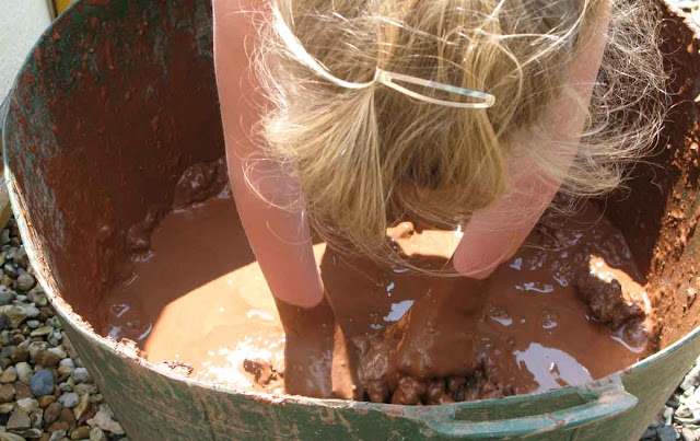 Children love to help out with the mud - clay.