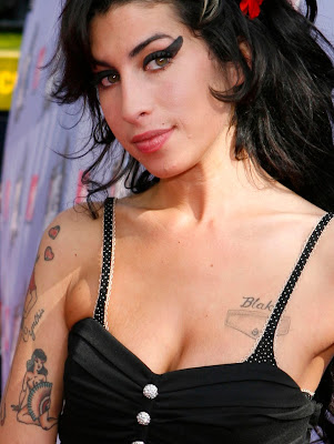 Amy Winehouse has quite a few tattoos designs among them are two topless