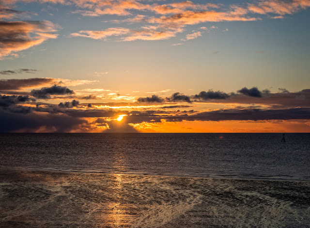 Photo of sunset across the Solway Firth from Maryport shore