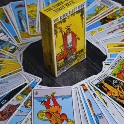 Tarot card deck surrounded by tarot cards laid out in a circular pattern, illustrating essential tips for using tarot.