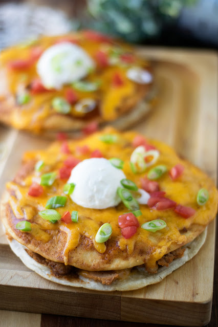 Two Crispy Mexican Pizzas on a board.