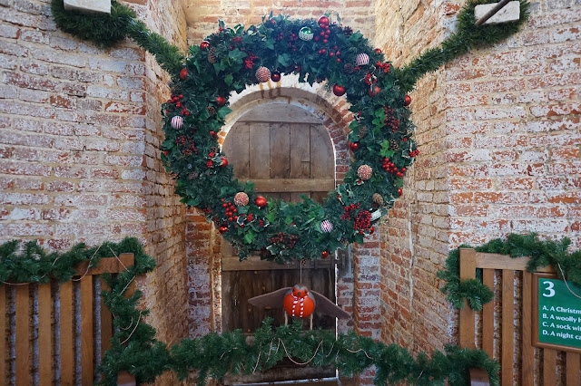 Decorated Wreath, with a large wooden Robin in a stone buliding