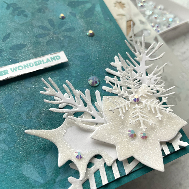 Winter Wonderland Holiday Cards made with: Tim Holtz modern festive die, rock candy distress glitter, distress spray stain, distress oxide, distress mica stain; Scrapbook.com solar white cardstock, wordfetti fa la la stamp, peppermint winter stencil, cools jewels smooth cardstock; Pinkfresh jewels; Pima watercolor paper