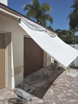 sun tarp for protection while painting a garage door to look like wood