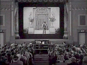 Buster Keaton about to climb into the cinema screen