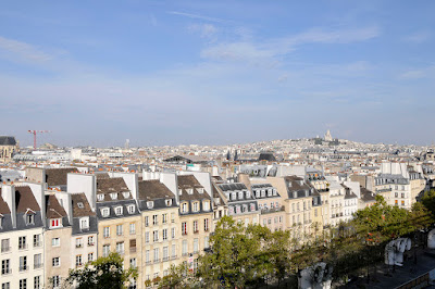 A scene of Haussmann architecture line up under blue sky in Paris