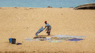 Laying wet towels on the beach to dry