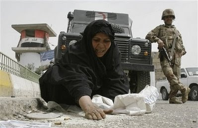 Yes, she's digging rice out of the gutter while an Iraqi soldier smiles like a fucking douche in the background. Good work, guys.