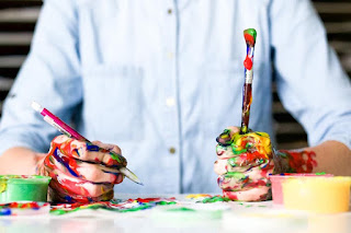 Man Wearing Blue Dress Shirt While Painting