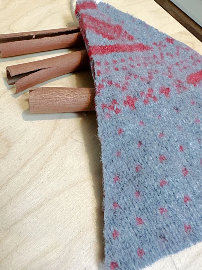 triangle of wool and cinnamon sticks