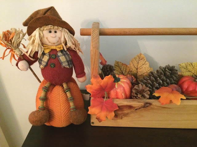 I enjoy mixing neutral shades with the traditional orange and yellows of fall to create a rustic fall mantel and wooden toolbox centerpiece.