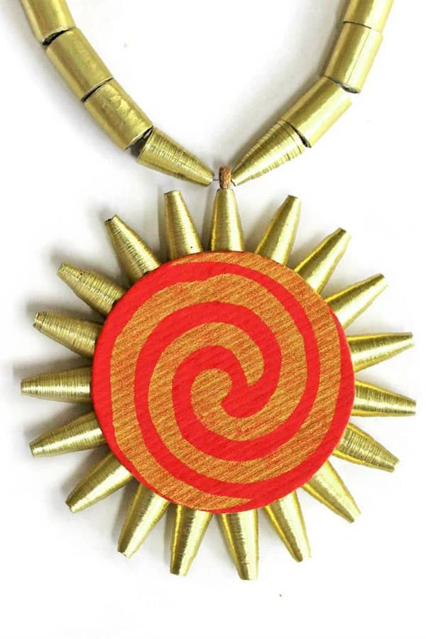 golden sun paper bead necklace with bold, spiral design paper at center