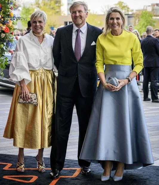 Queen Maxima, Princess Beatrix and Princess Laurentien attended the King's Day concert. Yellow top and gray blue skirt by Natan