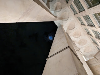 Under the portico of Palazzo della Libertà in Bergamo, with moon.