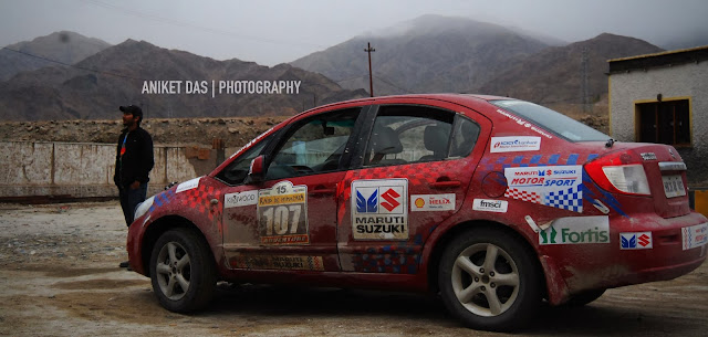 With the Raid comin to an end on the 12th of October 2013, 2 guys just like me (Samrat Yadav & Parminder Thakur, who were competitors in the rally) were clueless on how to get back home from Leh. Samrat had to go to Chandigarh, Parminder to Shogi and I had to get back to my college (National Institute of Design) in Ahmedabad.After a lot of fuss and confusion, Maruti Suzuki Motorsports decided that we were the capable bunch to hand over the keys to, of a competition car (SX4)thatneeded to be delivered to Manali. We jumped at the offer. We knew we could figure things out once we reach Manali.So without wasting anytime, we tagged along Harpreet Bawa in his Gypsy and left for a roadtrip that would test our survival skills!Little did we know what lay ahead. Everyone else had made plans of leaving the next day since something was brewing. We didnt have a clue. I think that just made things a lot better!But, when i look back i knew who to blame. Read through the pics, and lets hope it makes you live through the ordeals of the insane 'Afterparty' that commenced in the evening of the 12th of October, 2013. Happy & dandy, we were thoroughly excited about this roadtrip that would practically make us do a second round of the rally. We started capturing every milestone & settlement as we knew such an opportunity would be hard to find in the future. We wanted to keep a record of thijourney. Thank god for that! With 400+kms to Manali, we had a long trip ahead of us.  Some beautiful scenes like these did make us sing! Oh the joys of freedom 'Happy Journey' Yeah, thanks for that. Samrat waits as Parminder gets the toll ticket. Thats the SX4 by the way. She looked like she was back from a big war. I guess she was We've all got issues. So HIMANK's no exception. Yes HIMANK, we are enjoying the valley- now that the rally is over Temperatures kept falling and we saw clouds in the distance. This meant only one thing- IT WAS GOING TO SNOW! We jumped out of our cars and were on our feet balle-balle-ing And then we saw her-SNOW! Along with that, a reminder. I had already done Khardungla Top, being tied on top of a Bolero, now i needed to see what Tanglangla had in store for me The more we headed up the more serious things became And temperatures dropped below zero at exactly 5:55pm. Timing boss We were super pumped about the snow but something was going wrong. The car kept slipping...Keep watching this space to know what happens next...