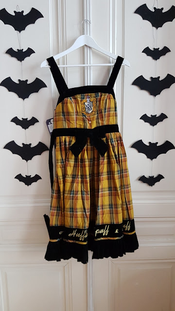 yellow plaid dress with black border and the word hufflepuff