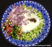 Cucumber cubes, onion, green chili,red chili yogurt and pepper