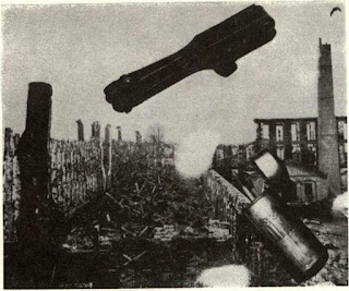 Placed across old photo of destroyed Colt’s Armory is bullet mould and London-stamped Pocket Model barrel, relics of fire salvaged from fused scrap. Old match box is symbolic of suspected Confederate arson though fire hazard conditions in factory made blaze of February, 1864, not totally unexpected.