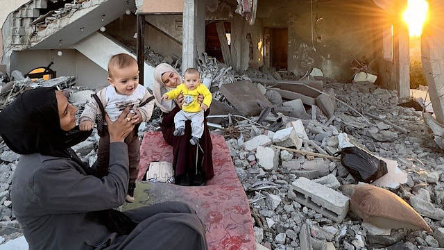 Mothers and babies in destroyed houses by Motaz Aaiza in Gaza