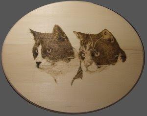 pyrography drawing of cats