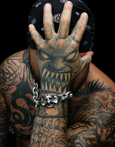 Nice black tribal dragon tattoo on a man's head