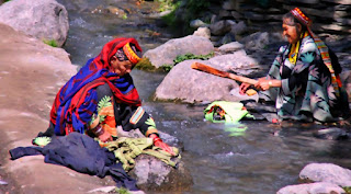 women washing clothes in river