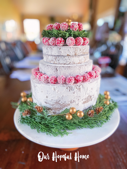 four layer faux naked cake red berries winter greens