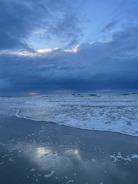 This is a view of the storm from moving in. It was taken from the sand on the beach, but the tide is very close to where I am standing. The clouds coming towards us are a dark gray and are pretty ominous as they sit over the open ocean.