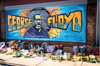 Image of mural with George Floyd's name and face with a sunflower in the background