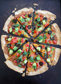 Crispy tortilla pizza with olives and tomatoes