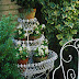 White Iron Planter with Green Moss and Begonias