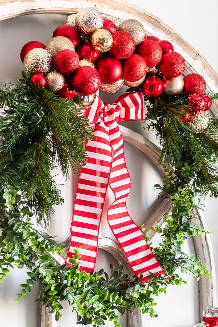 ornament cluster wreath, red and white striped ribbon bow