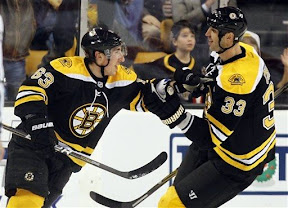 Brad Marchand celebrates with Zdeno Chara after Marchand scores his 3rd goal of the game