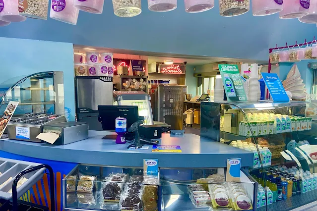 View of the cafe till area with drinks and snacks