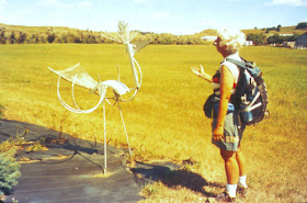 hiker talking to a metal bird