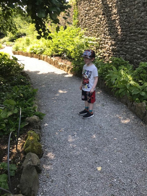 Little boy standing on the gravel path