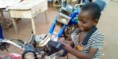 Photos: See this 8-year-old Ugandan boy who owns a motorcycle repair workshop