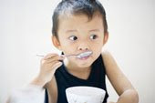 feeding seafood soup to a child