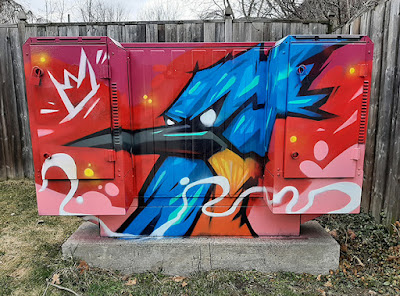 Bell Box decorated with a mural of a blue jay bird on a red background