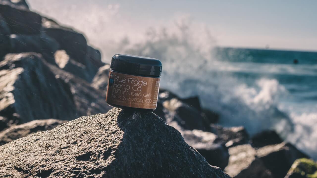 skincare product on top of a rock with ocean background | 10 Product Photography Ideas