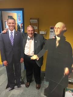 Dr. Wood with cardboard cutouts of Presidents Obama and Washington