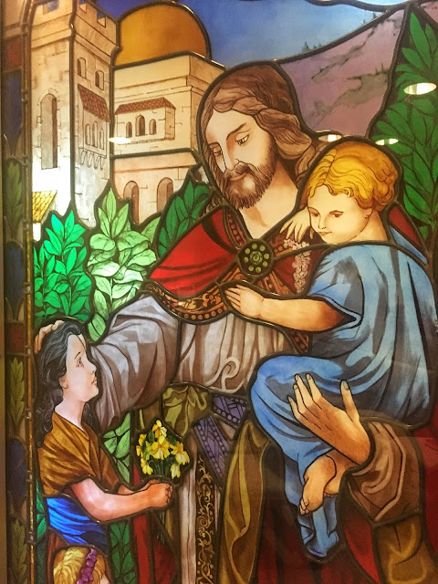 stained glass window depicting Jesus and children