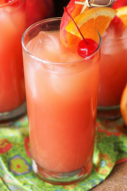 Gilligan's Island Cocktail with Peach, Orange, Cherry Garnish Image