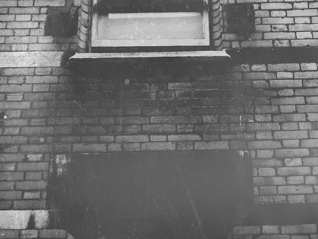 Brick wall with windows in black and white