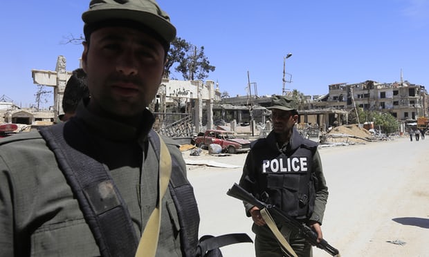 Syrian forces walk in Douma on the outskirts of Damascus. Photograph: Louai Beshara/AFP/Getty Images