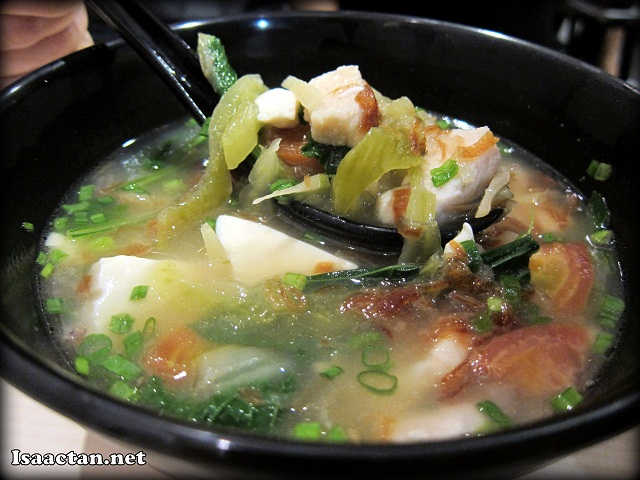 Soup of the day consisting of pickled vegetables, taufu and meat