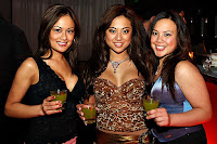 Myrna Star and other babes holding a drink in a nightclub