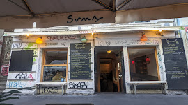 a heaviily grafitti'd cafe front