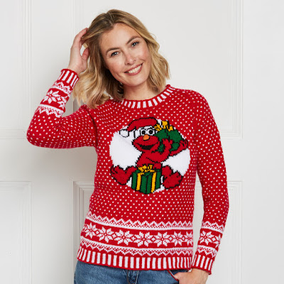 White lady wearing a red festive jumper with allover colourwork and large Elmo motif