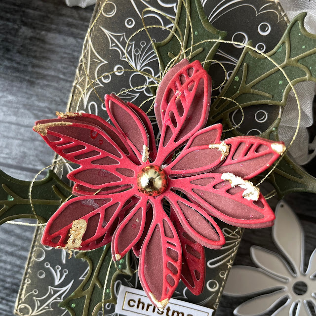 DIY Poinsettia Christmas gift tags made with: Tim Holtz Sizzix poinsettia seasonal sketch, holiday paper stash, cook kraft stock, rustic wilderness distress ink, crinkle ribbon, velvet trim; Scrapbook.com pops of color cherry pie, A2 smooth christmas cardstock, gold metallic ink, stickers, smart glue; WeR gold thread; Priam gold metallic flakes